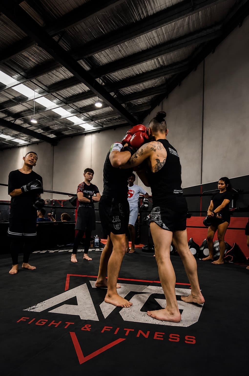 Adults training Muay Thai inside the ring at ATG Fight & Fitness